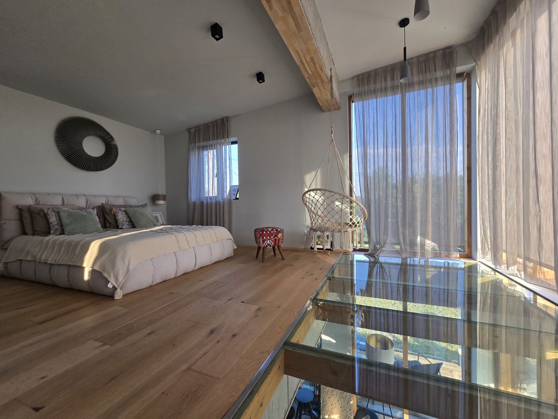 Glass-floor loft bedroom overlooking the living room