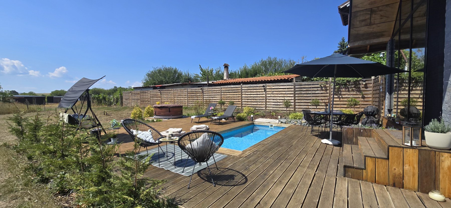 Pool deck with Acapulco chairs panorama